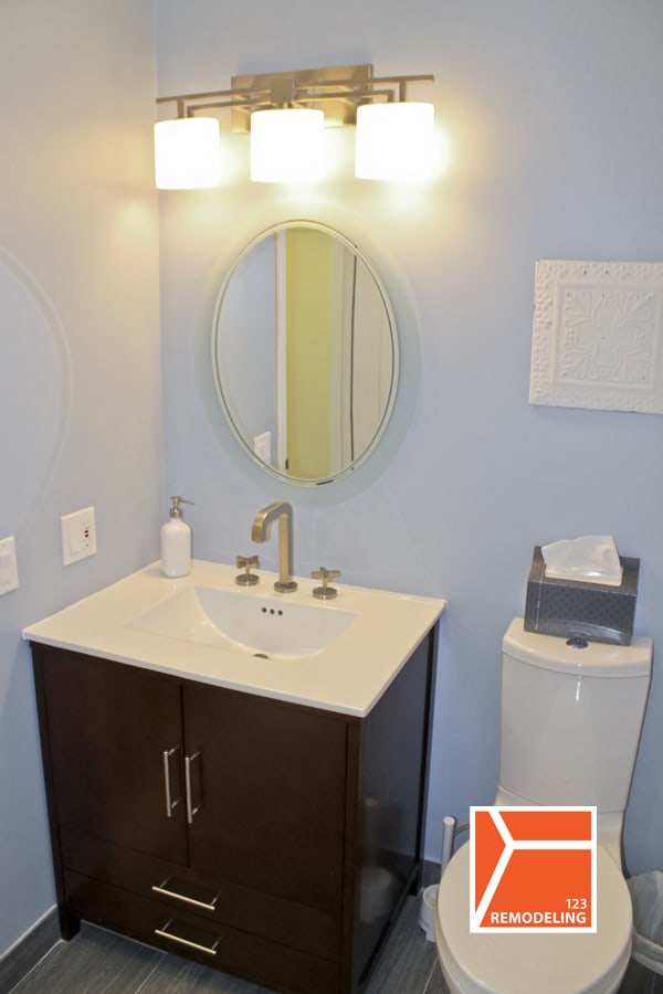 Slim, elongated modern styled toilet installed by 123 Remodeling creates more space and visually bigger bathroom.
