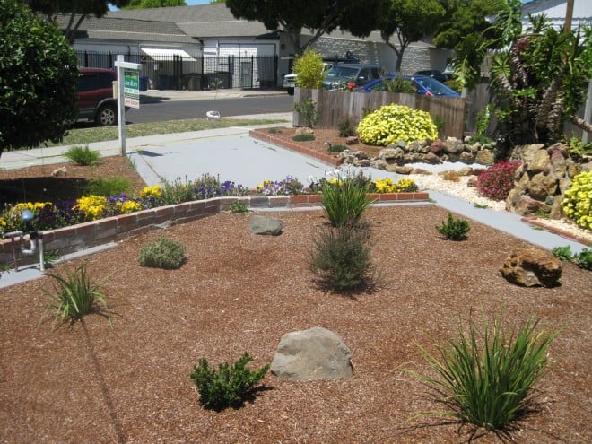 Beautifully landscaped front lawn of a remodeled home