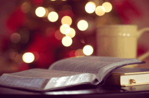 open book with coffee mug and fairy lights