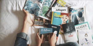 woman's feet next to a pile of books