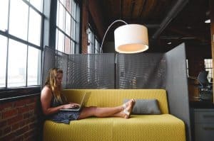 woman on office couch with laptop