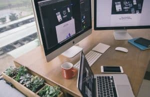 desk with computers and plants