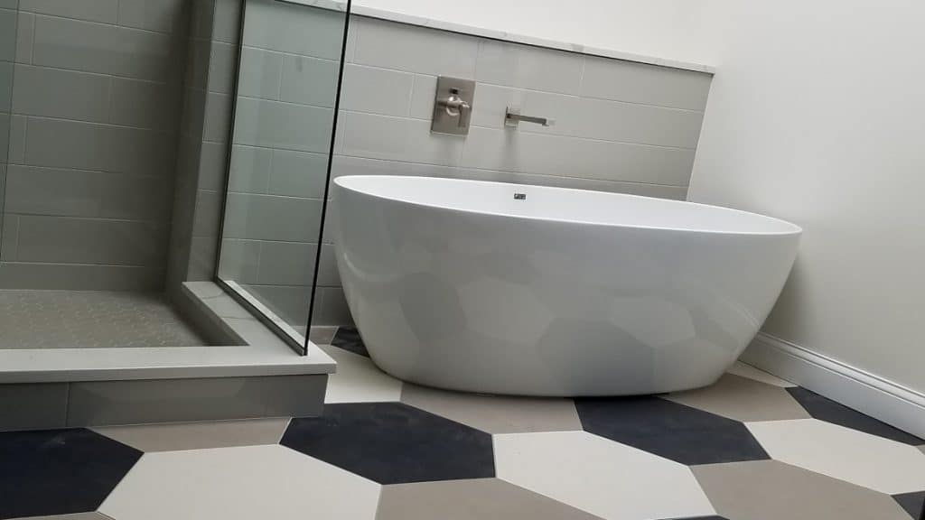 freestanding tub and hexagon tile flooring