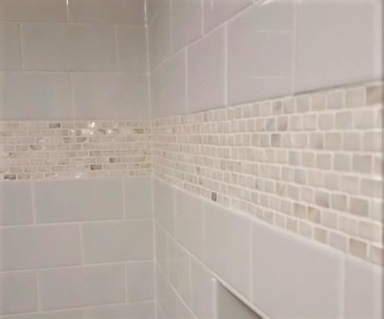 white shower wall with mother of pearl accent