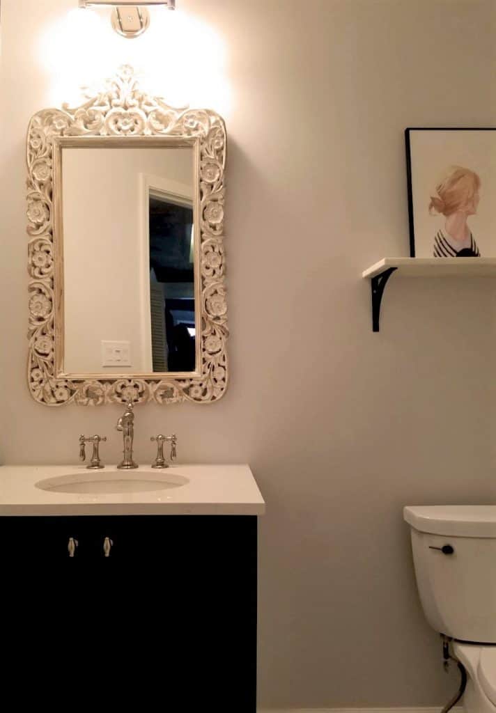 classic small bathroom with ornament mirror