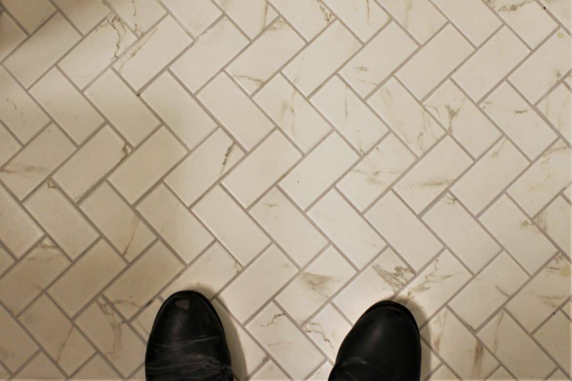 marble subway tile floor with herringbone layout