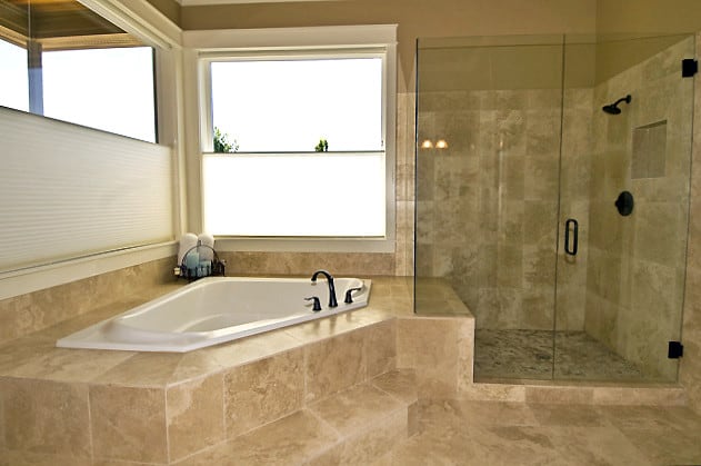 travertine tiled bathroom with tub and shower