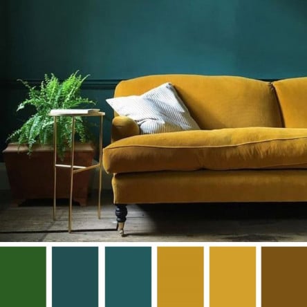 yellow velvet sofa and blue wallpaper