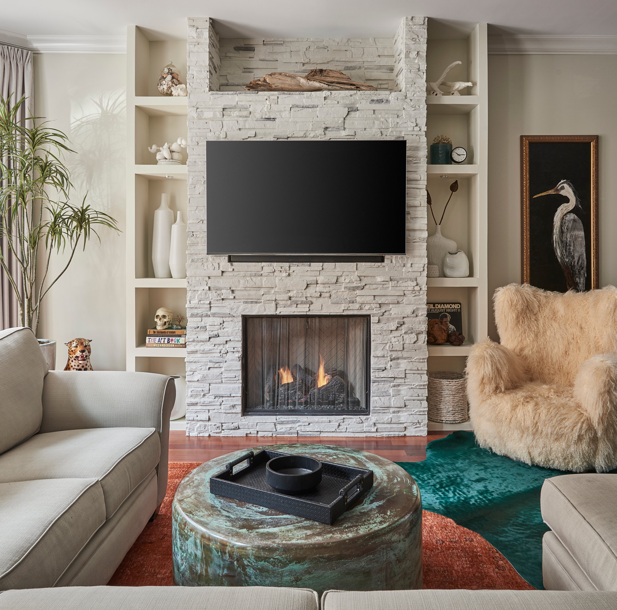 Living room - large 1960s formal and open concept medium tone wood floor and brown floor living room idea in Chicago with beige walls, a standard fireplace, a stone fireplace and a wall-mounted tv